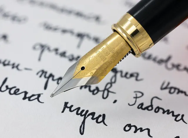 Hand signing a will document with a pen