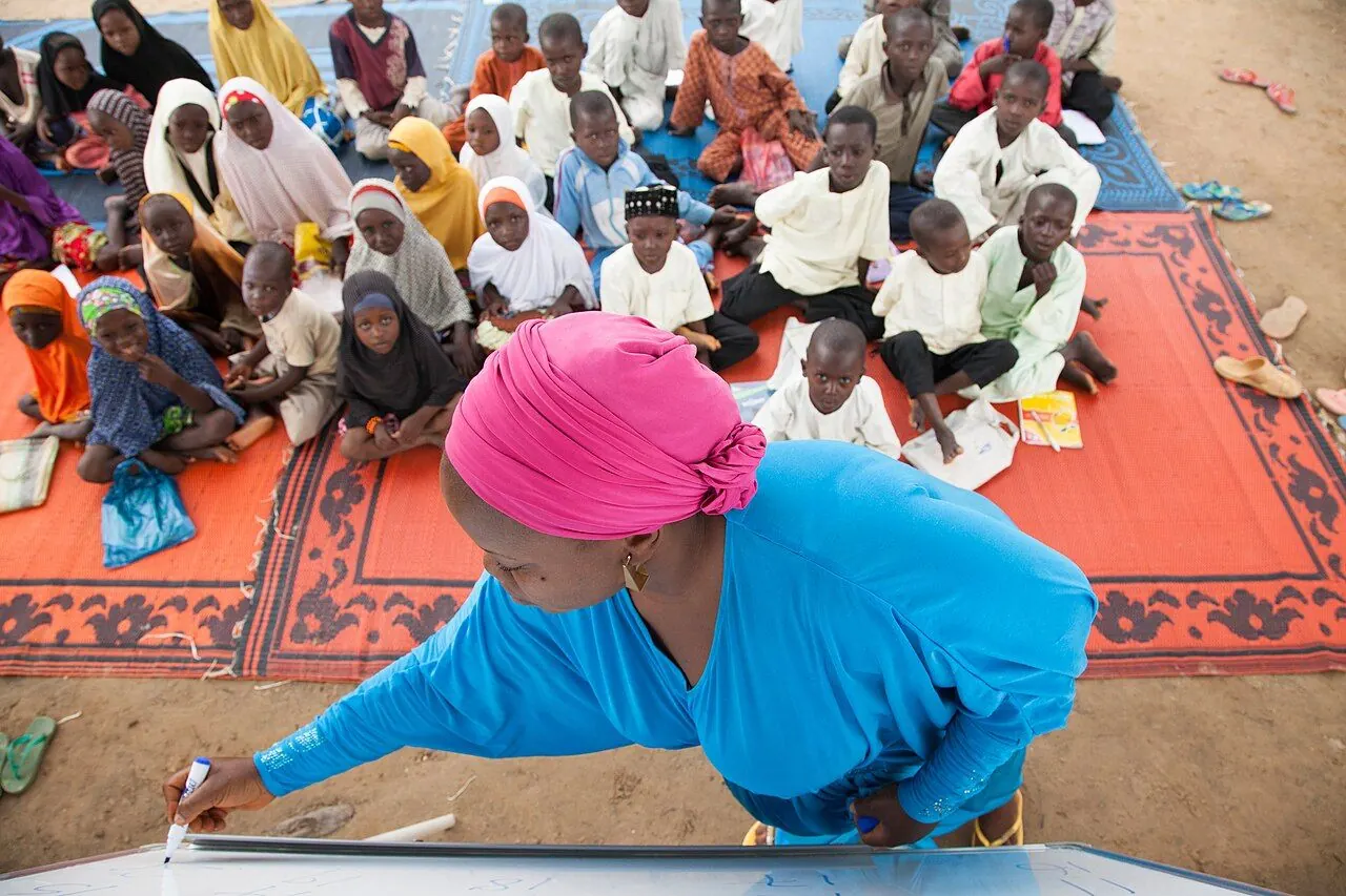 Volunteer with a backpack at an overseas community project